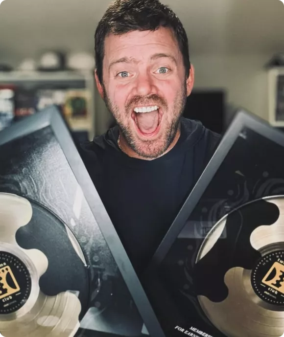 Accountability Now founder holding achievement awards, representing business growth and coaching success.