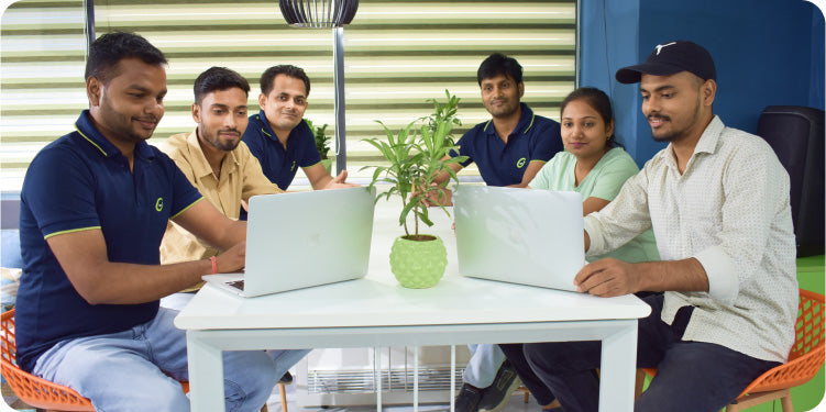 Team brainstorming funnel strategies together around laptops in the CF Funnels workspace.
