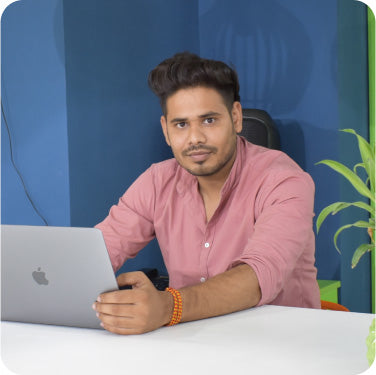 Team member focusing on funnel development tasks using a laptop in the CF Funnels office.