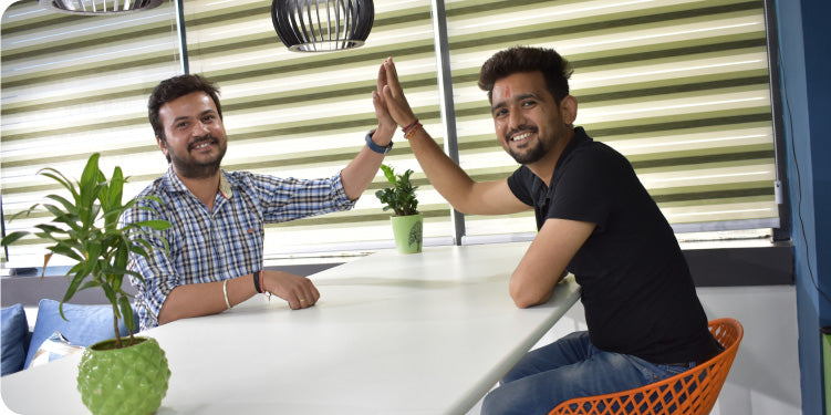 CF Funnels team members celebrating progress with a high-five during a collaborative session.
